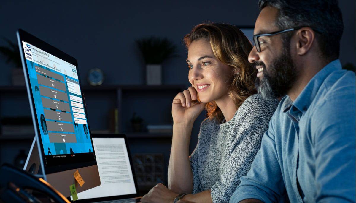 Business Applications by Crow Canyon Software Couple looking at Employee Self-Service Portal by Crow Canyon Software