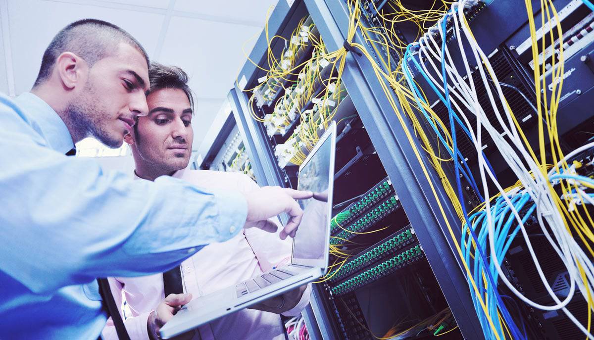 Two men working in a Server Room Two men looking at equipment tracking software in server room