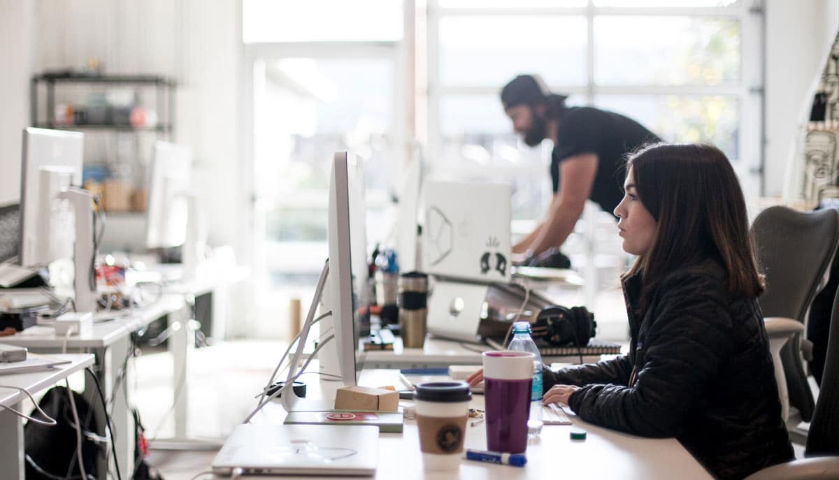 Woman At Computer, HR Reuqests Woman looking at computer in office, fulfilling a HR Request forms